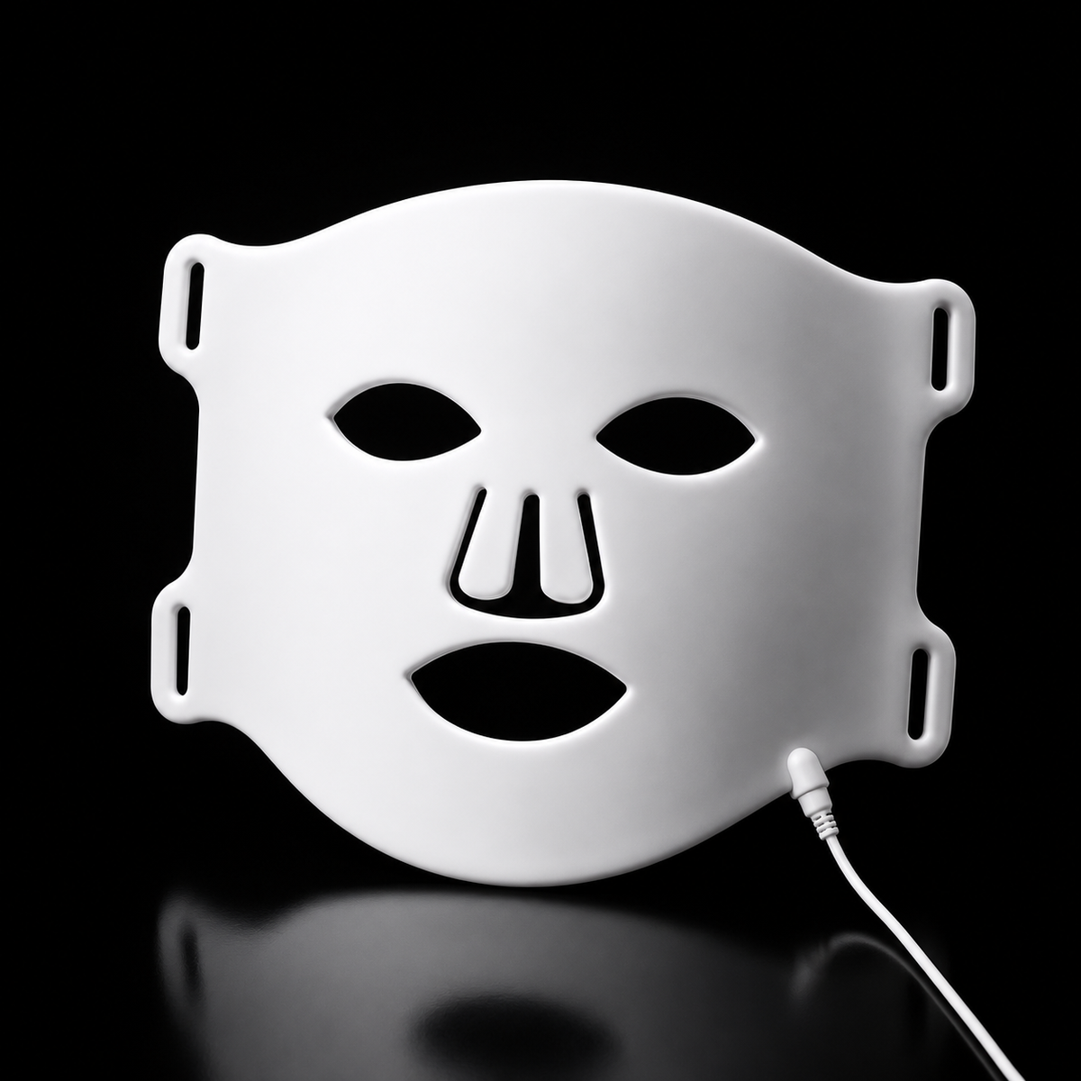 White silicone LED light therapy face mask used for an at-home skincare routine
